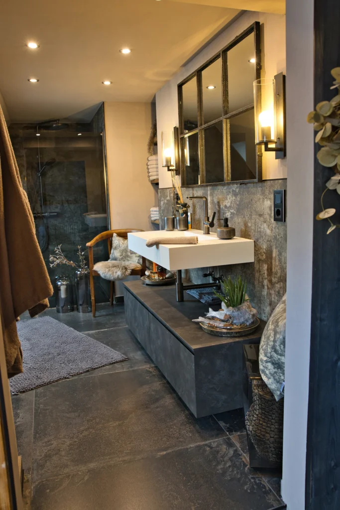 Modernes Badezimmer mit dunklen Bodenfliesen, freihängendem Waschtisch und schwarzen Armaturen in Queidersbach