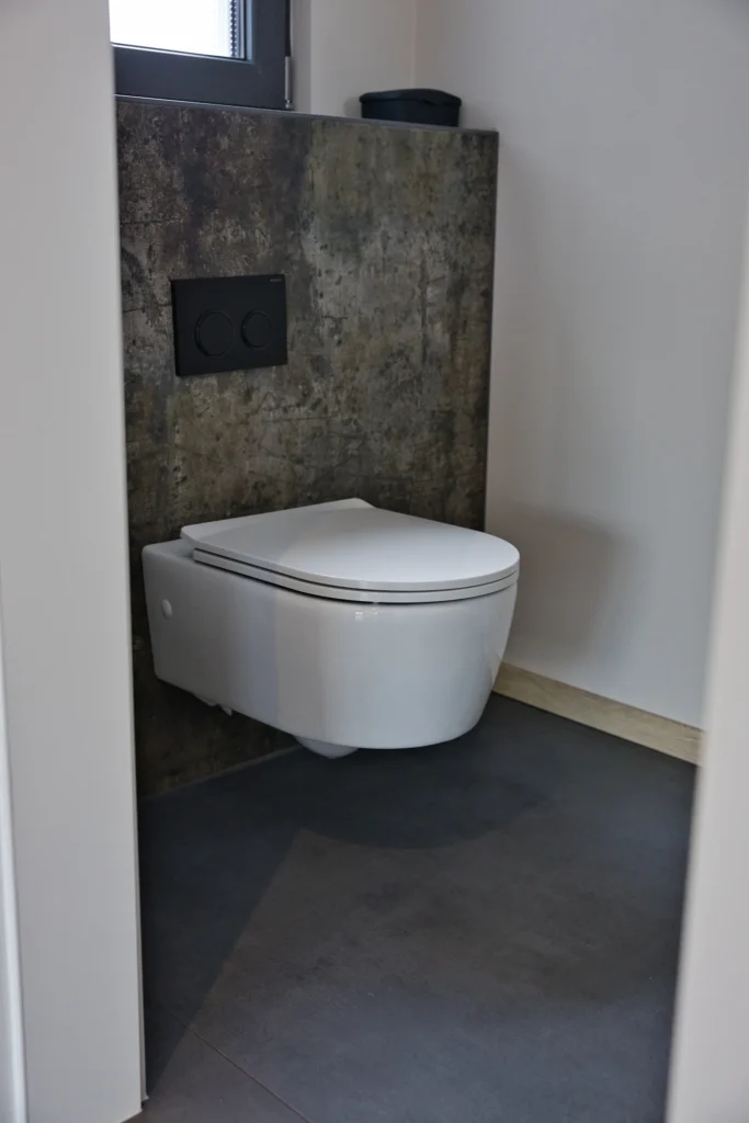 Wandhängendes WC vor Fliesen in Betonoptik – modernes Gäste-WC mit klaren Linien